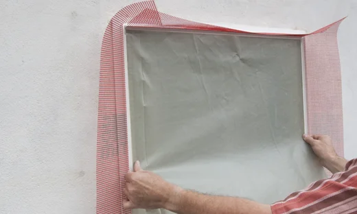 Schutzfolie auf Klebestreifen der Anputzleiste am Fenster anbringen.
